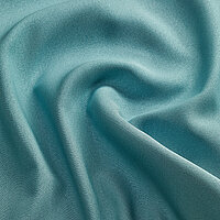 Nahaufnahme des SONARA, in der Farbe grün, zeigt die feine Struktur und das Textilmuster.